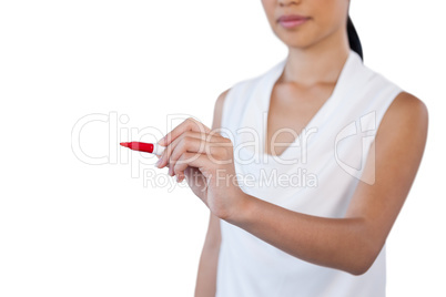 Mid section of young businesswoman writing on invisible glass