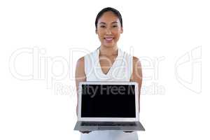 Portrait of smiling businesswoman holding laptop