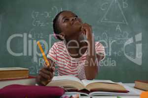 Schoolgirl doing his homework in classroom