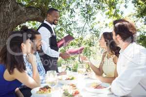 Friends placing order to waiter