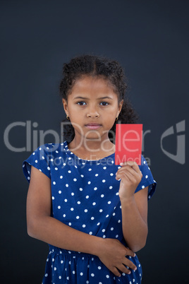Portrait of girl showing red card