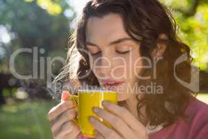 Thoughtful woman having a cup of coffee