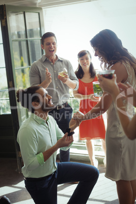 Man proposing woman with engagement ring