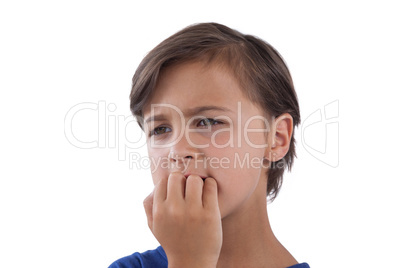 Thoughtful boy biting finger