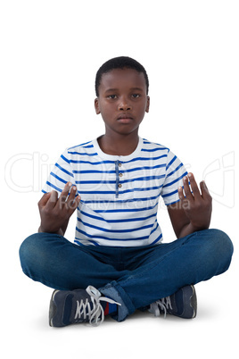 Portrait of boy performing meditation