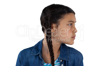 Thoughtful girl standing against white background