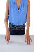 Mid section of businesswoman gesturing on table