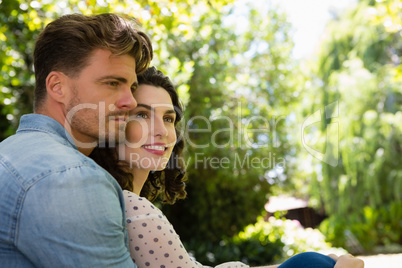 Couple embracing each other in garden on a sunny day