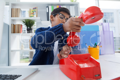 Businessman holding receiver of landline phone