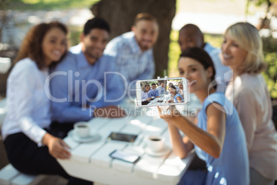 Group of friends taking selfie on mobile phone