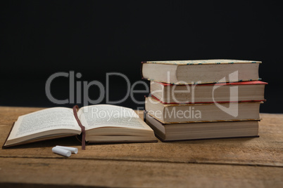 Books and chalk on table