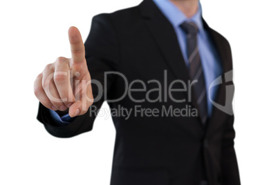 Mid section of businessman touching index finger on invisible screen