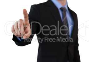 Mid section of businessman touching index finger on invisible screen