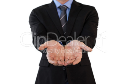 Mid section of businessman in suit standing with hands cupped