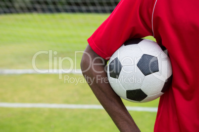 Cropped image of male soccer player holding ball