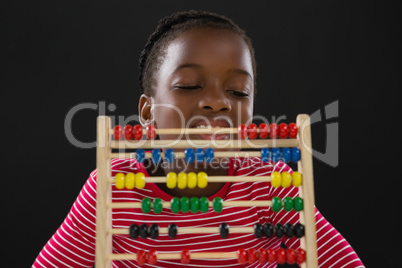 Cute little girl counting on abacus