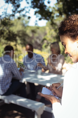 Waitress writing order on notepad