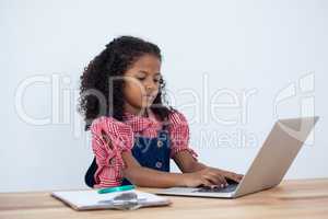 Businesswoman using laptop computer at desk