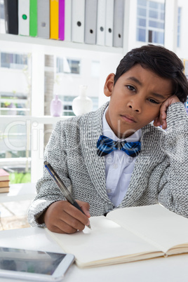 Portrait of bored businessman sitting in office