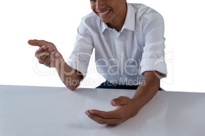 Teenage boy pretending to work on an invisible object