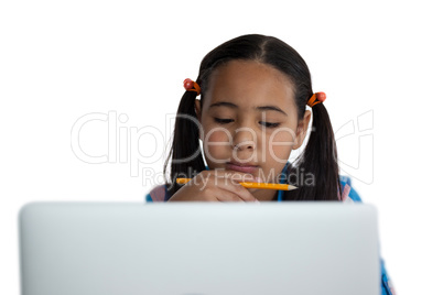 Thoughtful girl using laptop