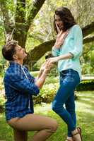 Handsome man proposing woman by gifting ring