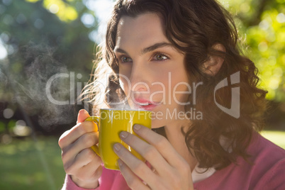 Thoughtful woman having a cup of coffee