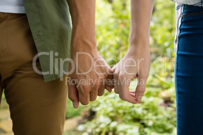 Mid-section of couple holding hands