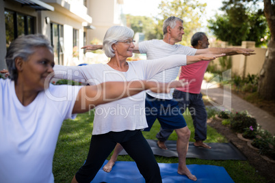 Multi-ethnic senior people stretching while exercising