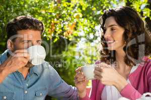 Couple having cup of tea in garden