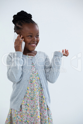 Cheerful businesswoman gesturing while talking on phone