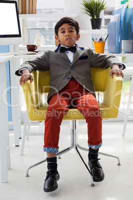 Portrait of businessman sitting on armchair