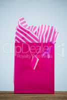 Close-up of vibrant pink Breast Cancer Awareness ribbon on shopping bag