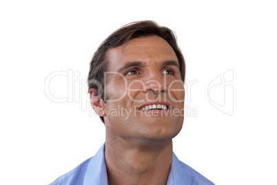 Thoughtful mature businessman smiling while looking up