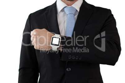 Mid section of businessman in suit showing smart watch