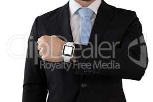 Mid section of businessman in suit showing smart watch