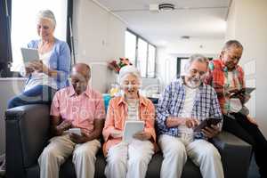 Smiling senior people using tablet computer