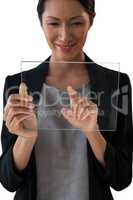 Smiling businesswoman touching glass interface