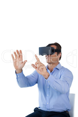 Businessman using vr glasses while sitting on chair