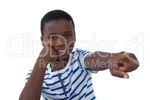 Happy boy pointing his finger against white background
