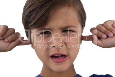 Cute boy covering his ears against white background