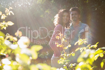 Smiling couple standing together in garden