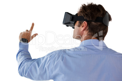 Rear view of businessman gesturing while using vr glasses