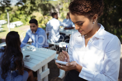 Waitress writing order on notepad