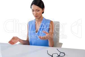 Businesswoman gesturing while sitting at table