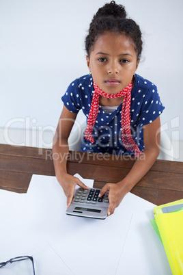 High angle view of businesswoman using calculator