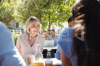 Friends interacting with each other in restaurant