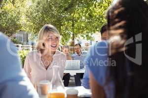 Friends interacting with each other in restaurant