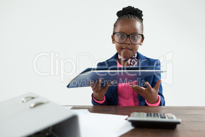 Portrait of businesswoman wearing eyeglasses holding file