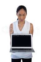 Businesswoman holding laptop computer